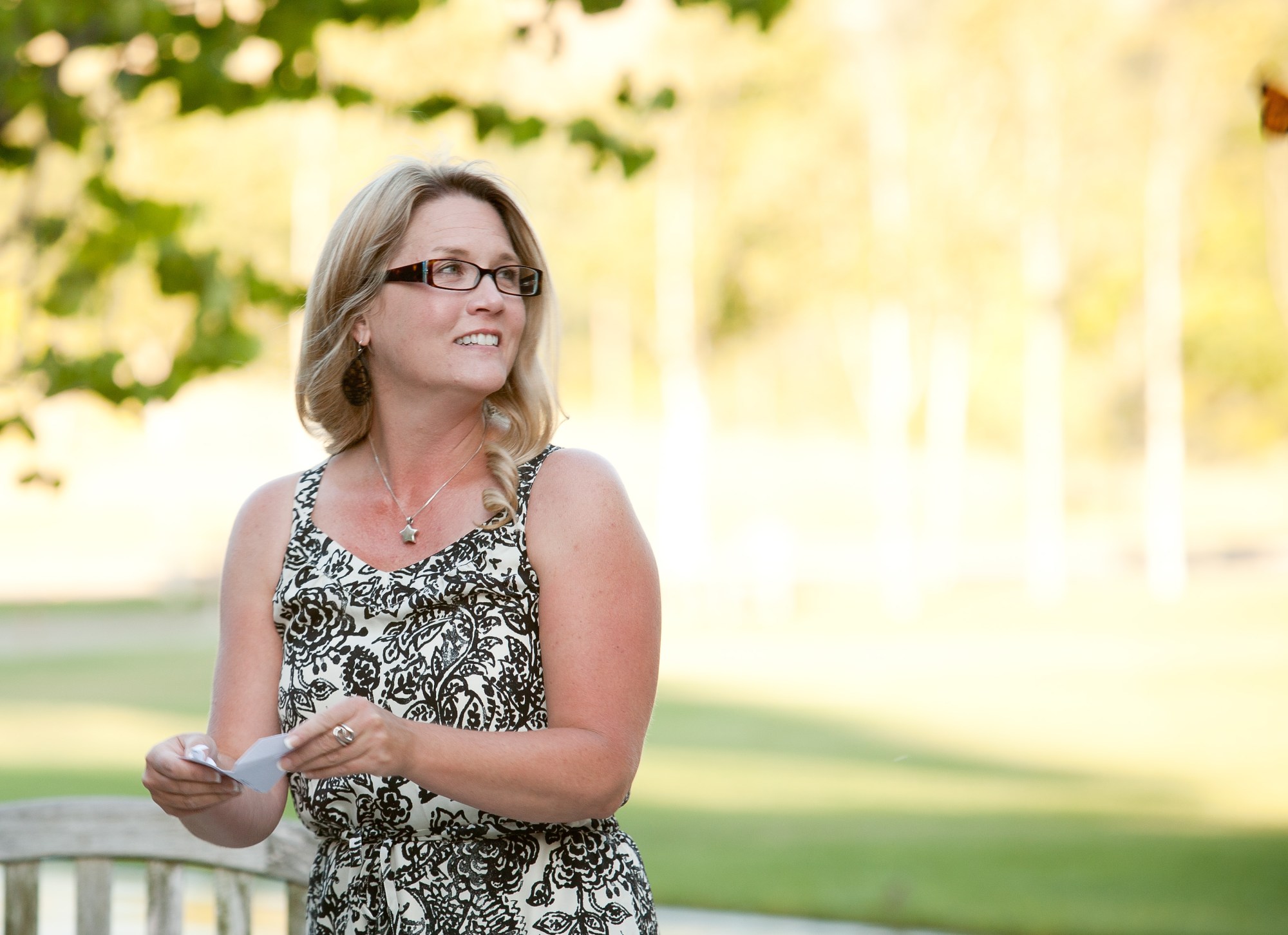 Raina releases a butterfly in memory of Nora.