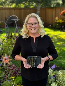 Nora's mother, Raina, holds her Hearts of Gold Award.